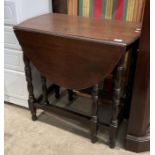 An oak drop leaf gate leg oval side table,