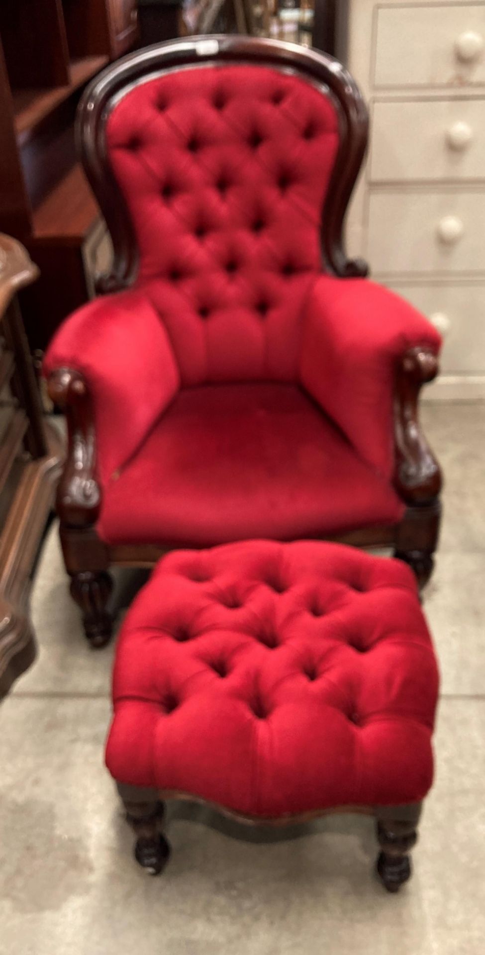 A Victorian style mahogany framed nursing armchair upholstered in red dralon with deep buttoned
