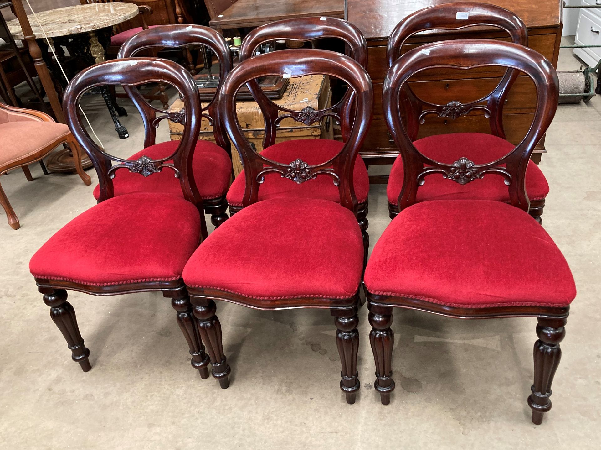 A set of six Victorian style balloon back dining chairs with red dralon upholstered seats (MS)