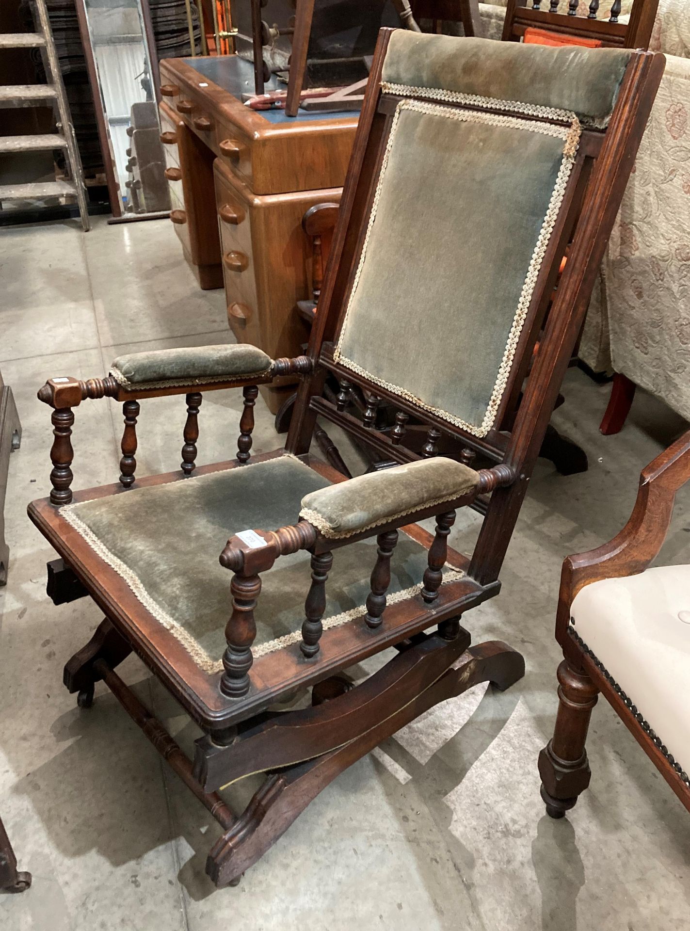 A stained wood American rocking chair with green fabric upholstery (MS)