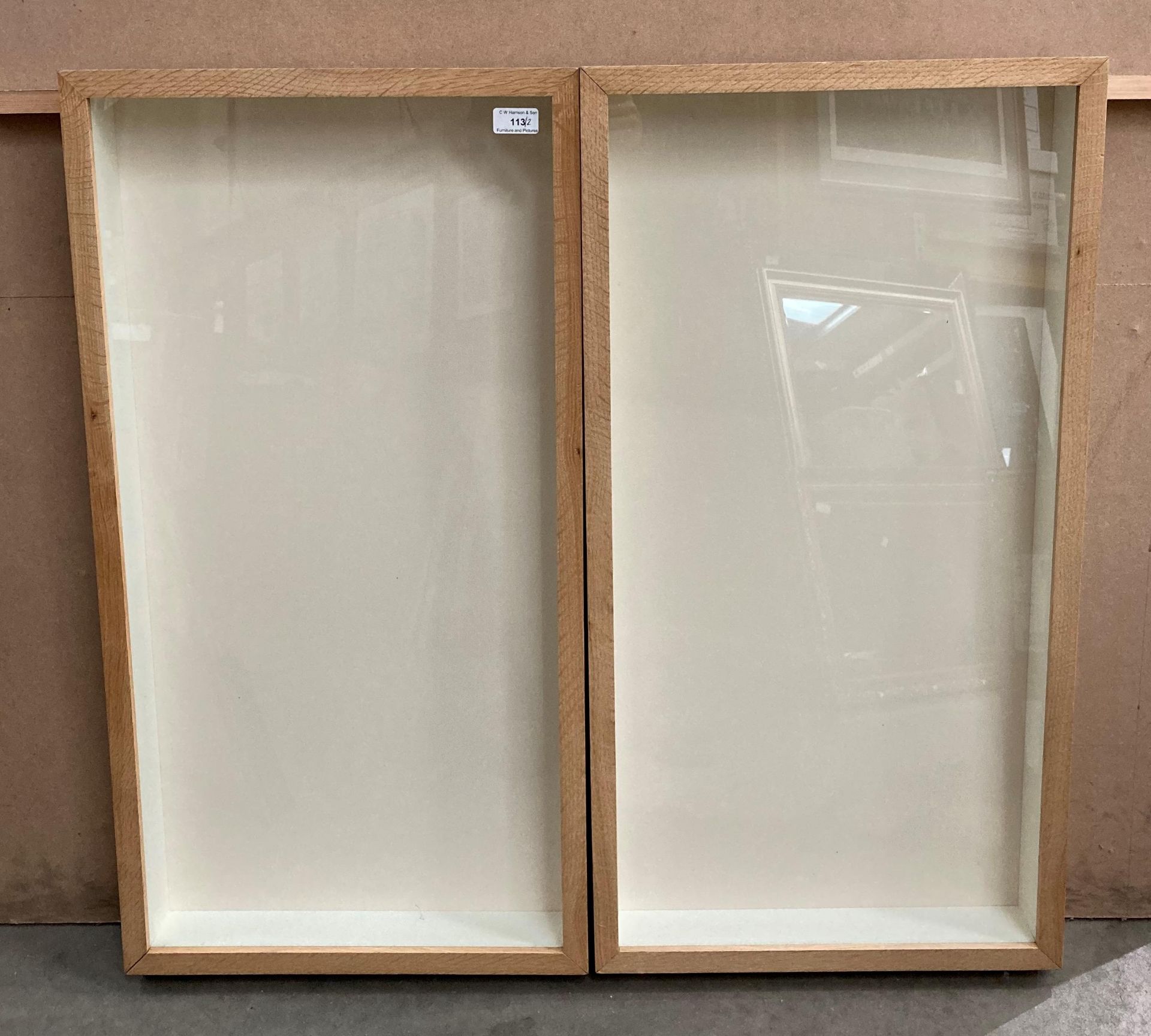 A pair of light oak framed wall mounting display cases,