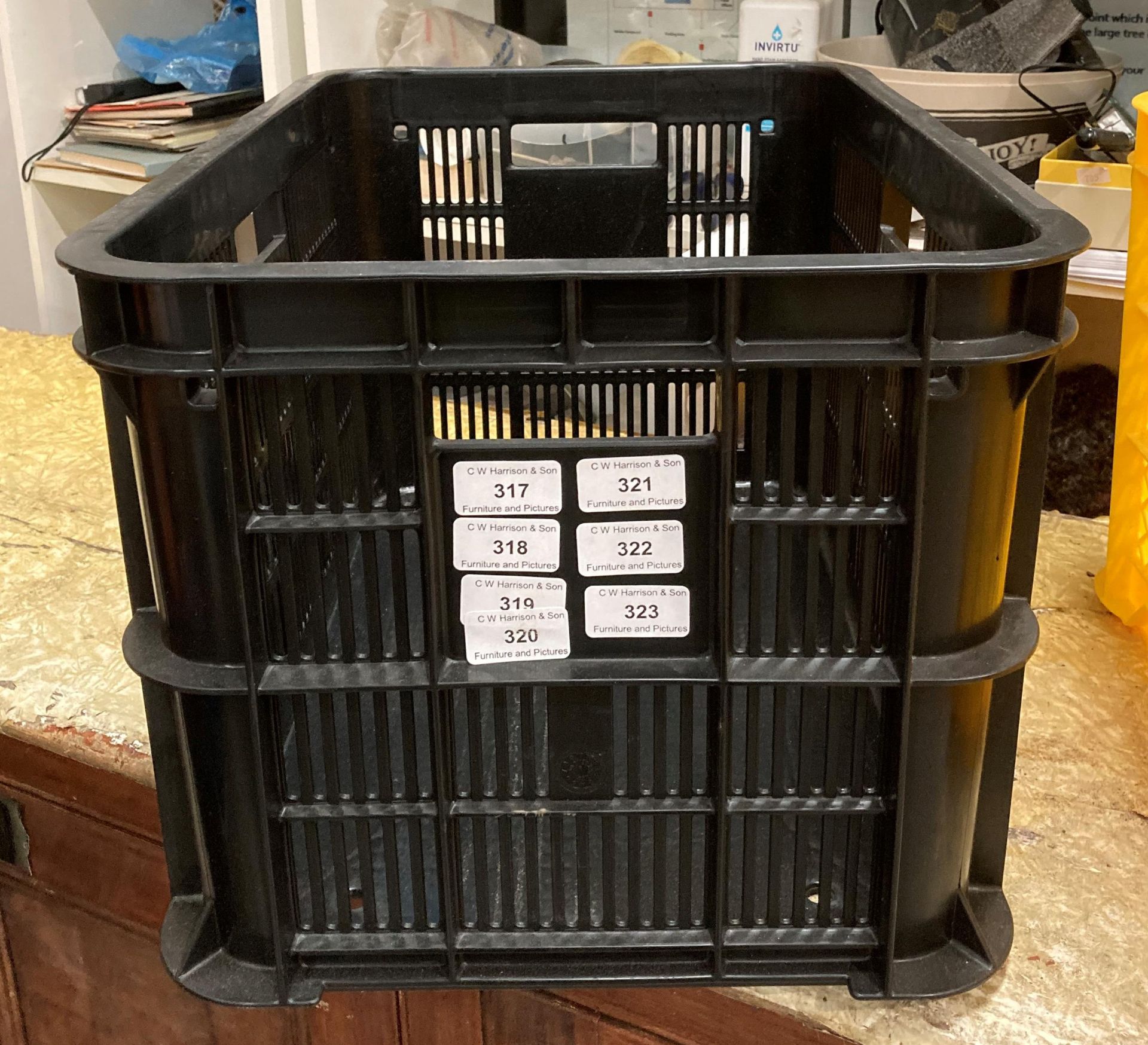 Twenty black plastic crates,