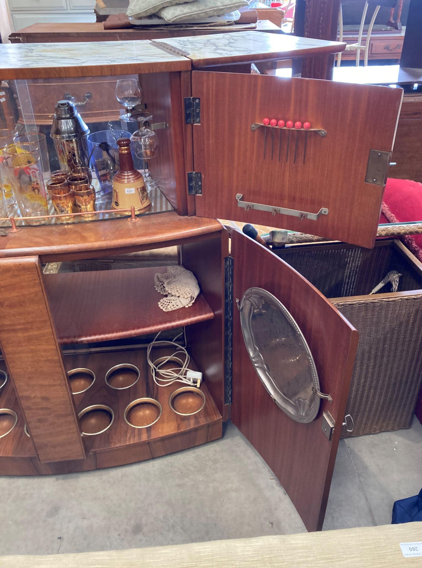 A 1950s walnut finish curved double sided bar with marble effect folding top over two doors and - Image 4 of 7