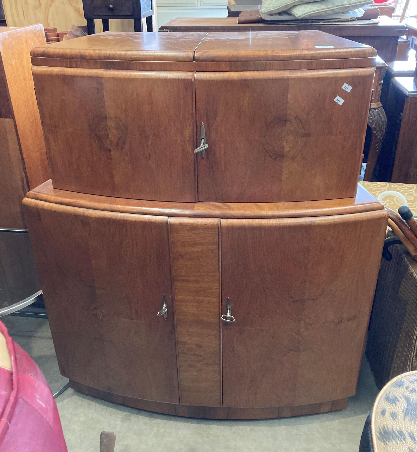 A 1950s walnut finish curved double sided bar with marble effect folding top over two doors and - Image 2 of 7