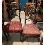 A pair of mahogany salon chairs with carved centre splat back and red patterned fabric seats,