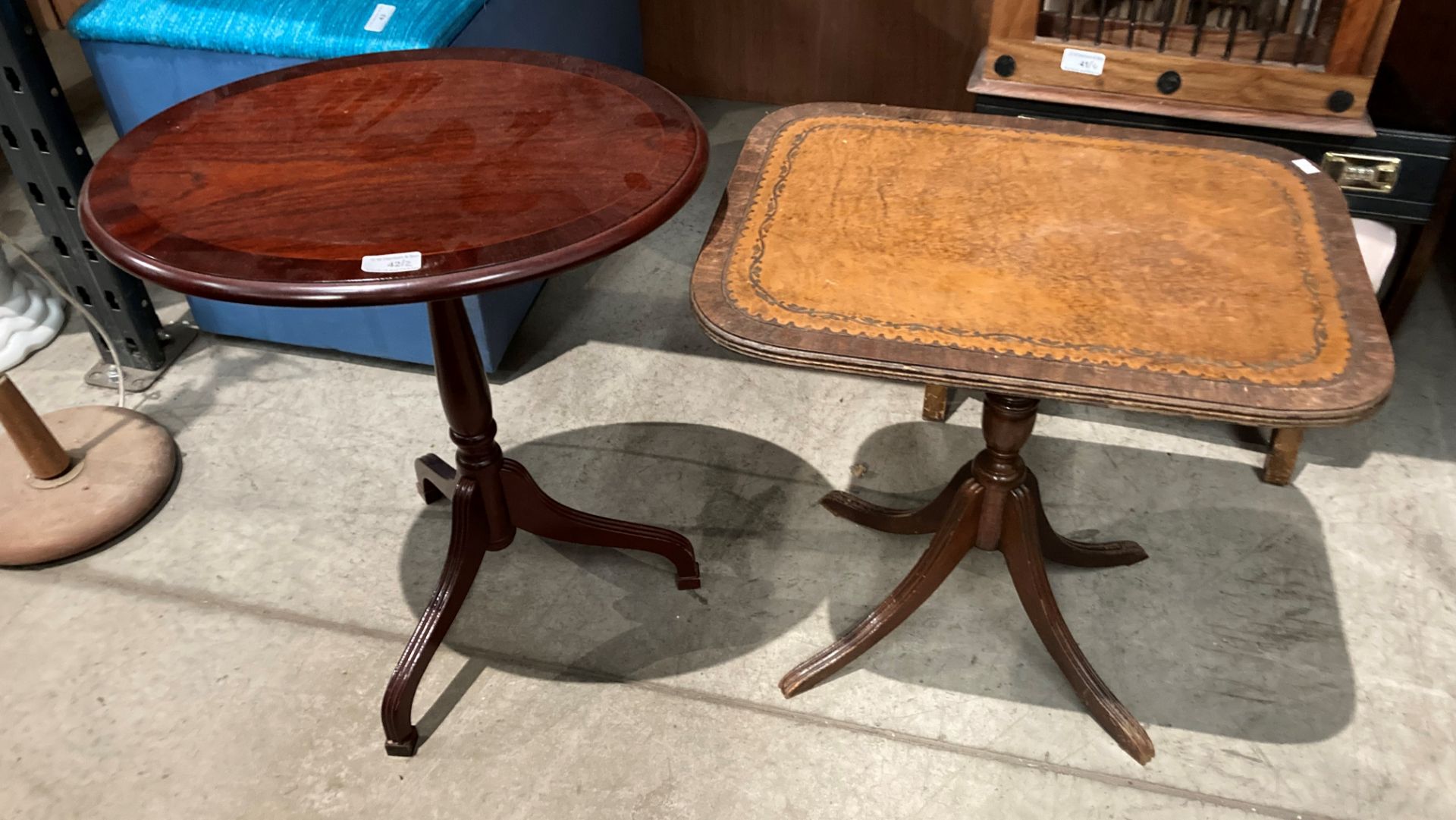 A small reproduction mahogany oval side table and a mahogany side table with light brown tooled