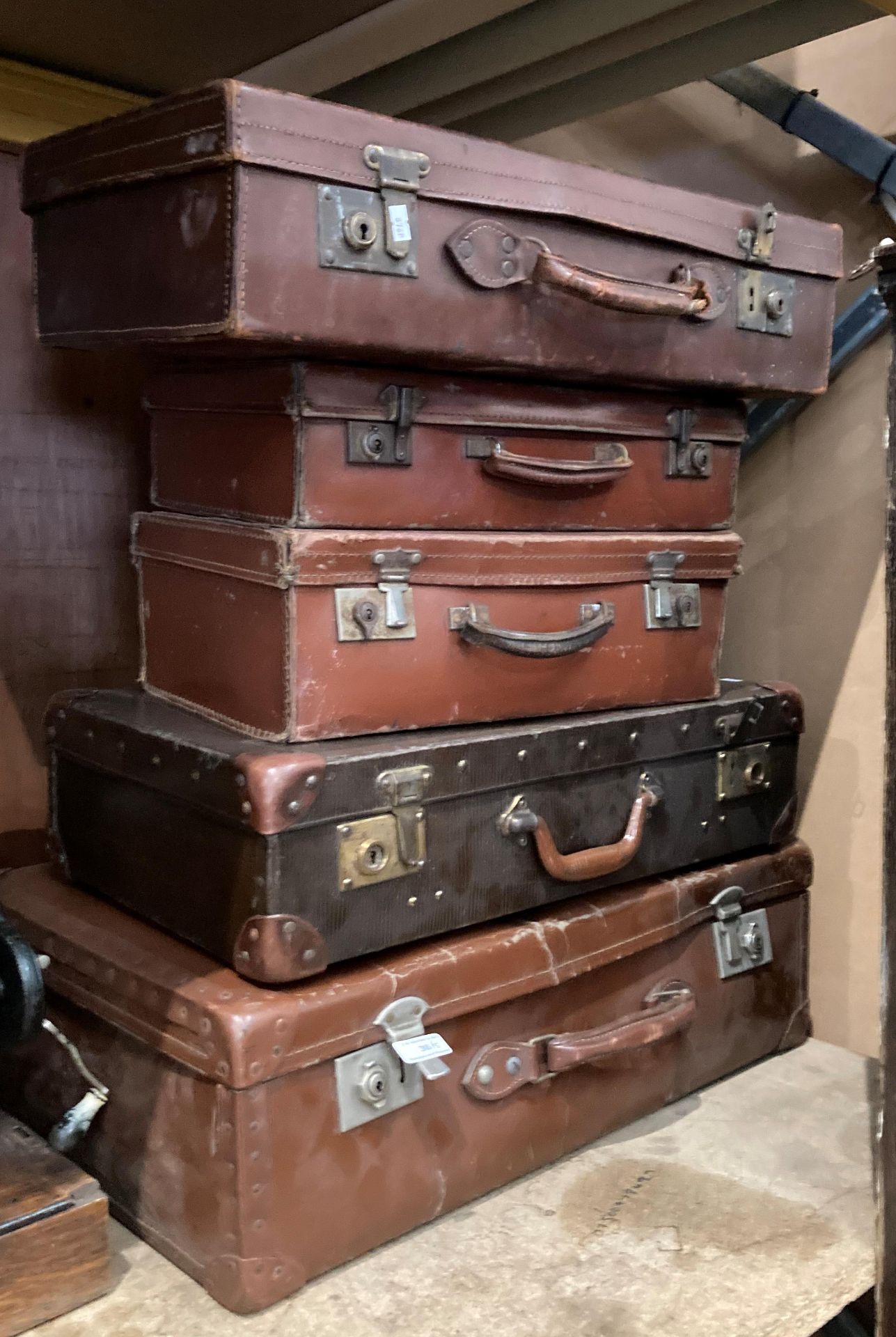 Five various brown fibre and leather suitcases (MST)