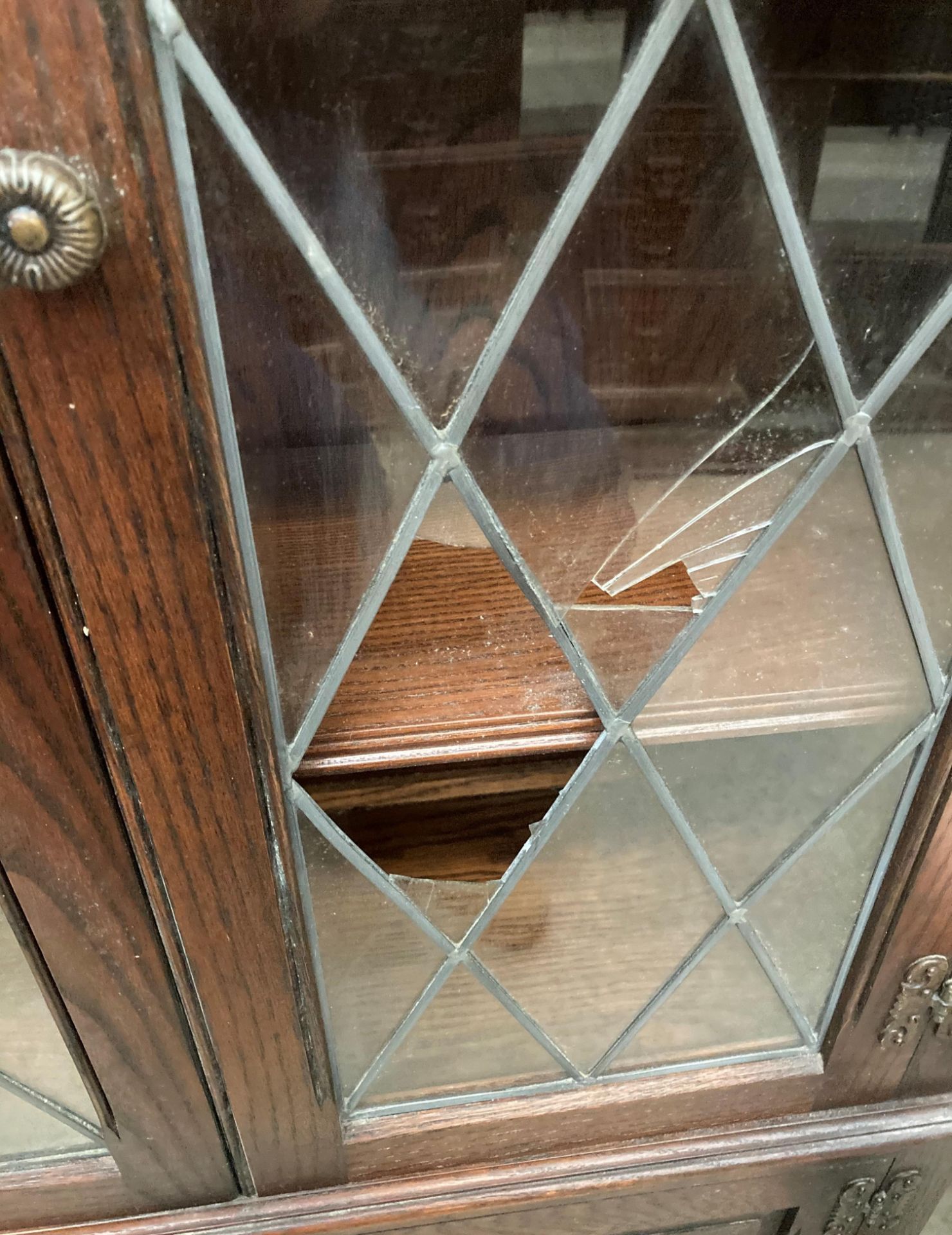 An Old Charm oak display cabinet with two leaded glazed doors (one damaged) over two door base, - Image 2 of 4