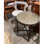 A Benares brass top circular coffee table 50cm diameter and a white painted bentwood armchair (2)