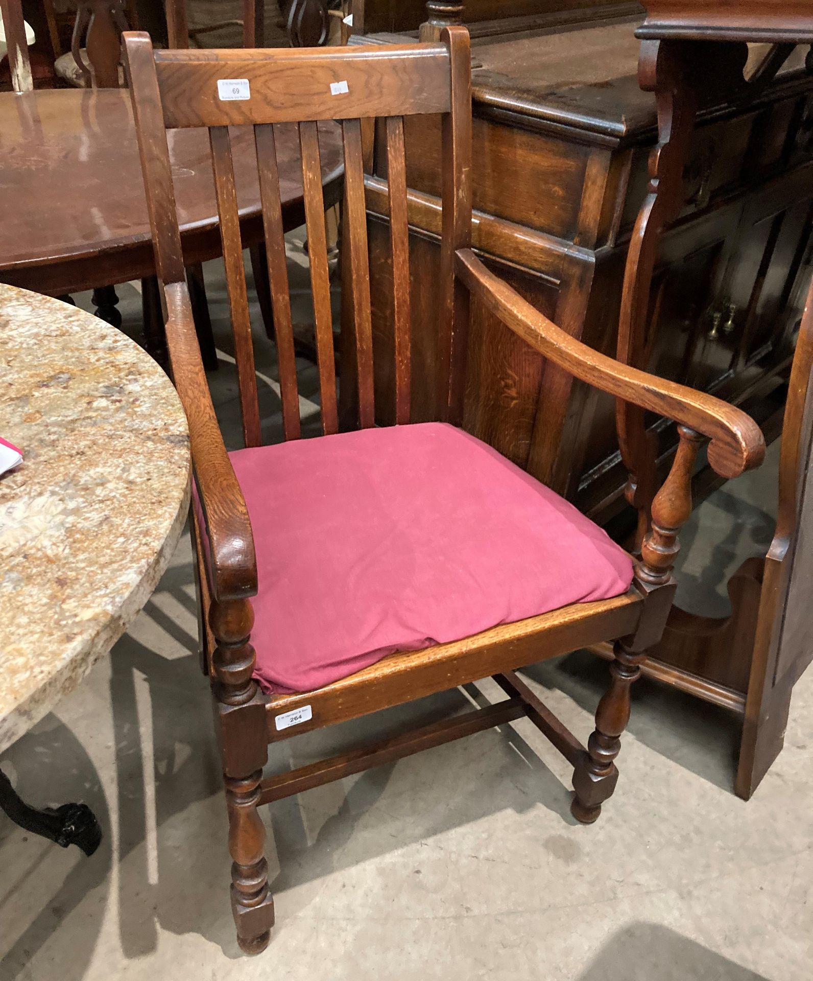 An oak framed armchair with pink fabric upholstered seat (S2T)