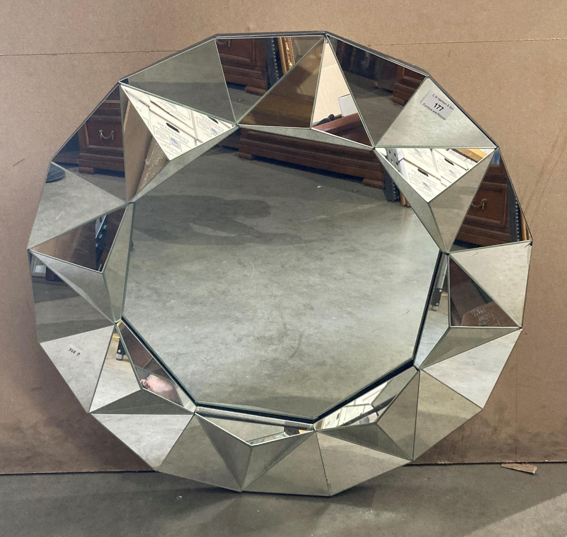 A Heart of House circular wall mirror with raised shaped perimeter,