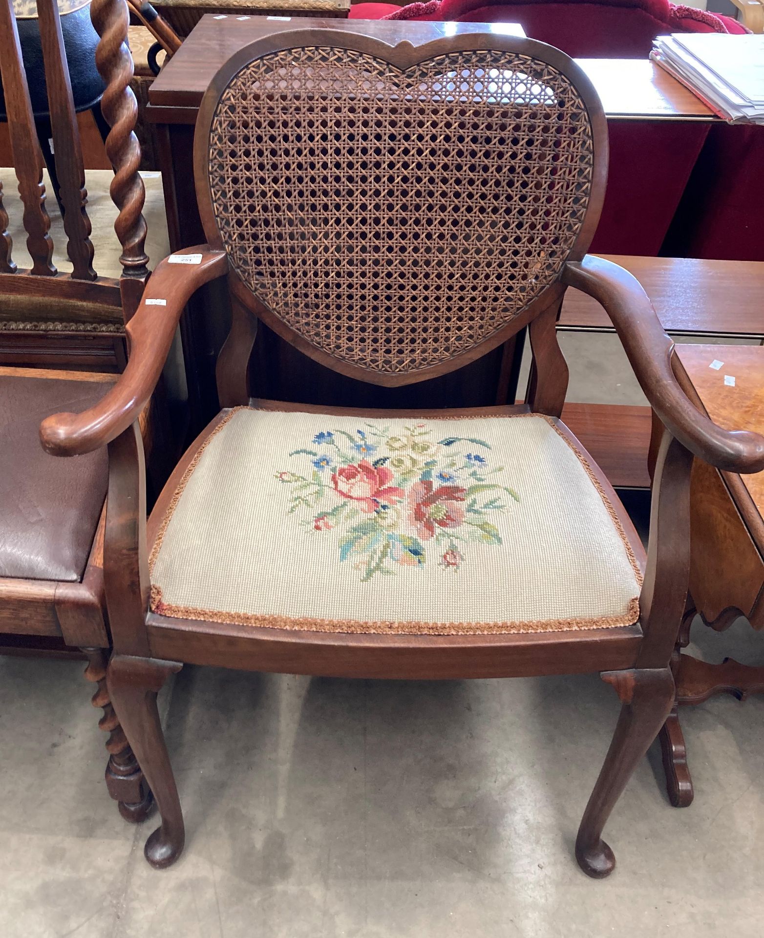 An oak framed armchair with tapestry seat and heart shaped woven back (MS)