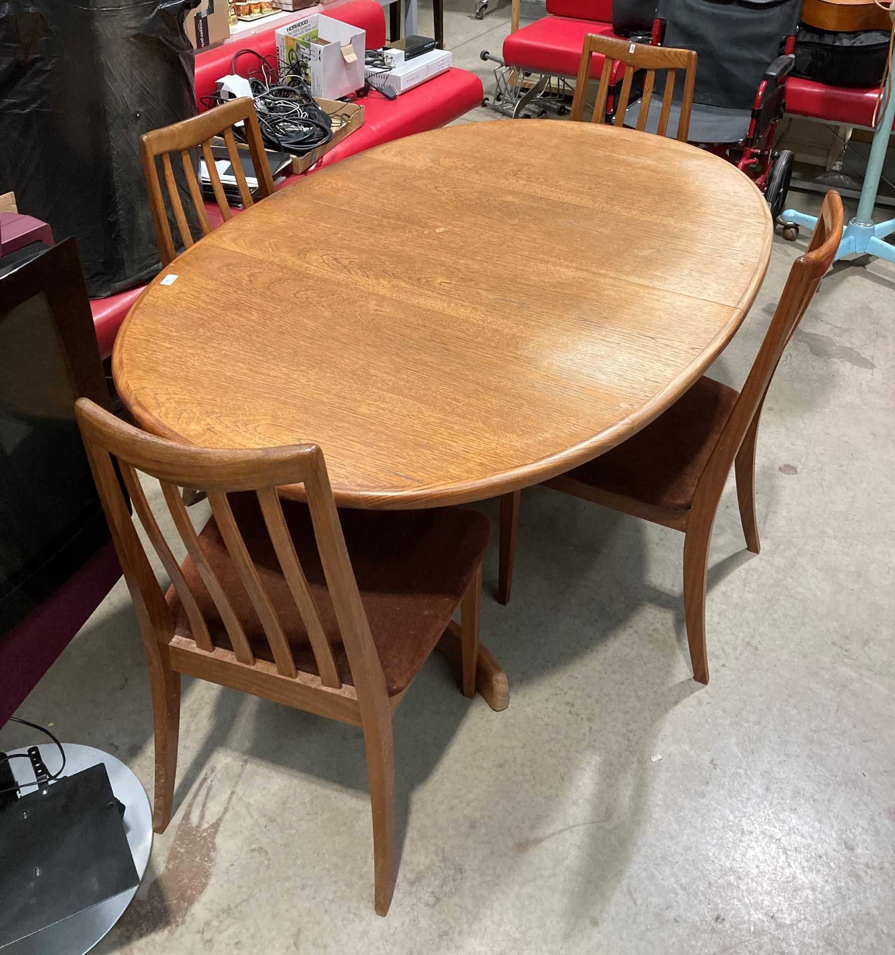 A G-Plan teak extending top oval dining table 106cm x 200cm when extended together with four