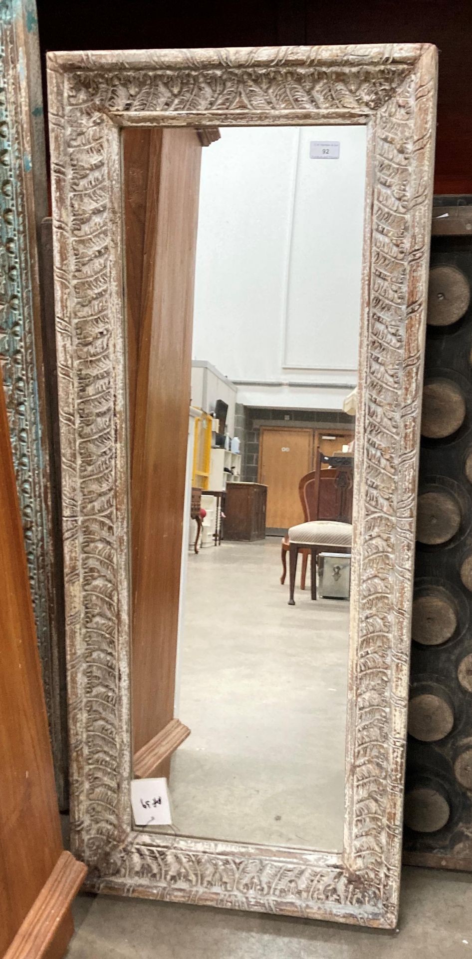 A distressed finish framed wall mirror,