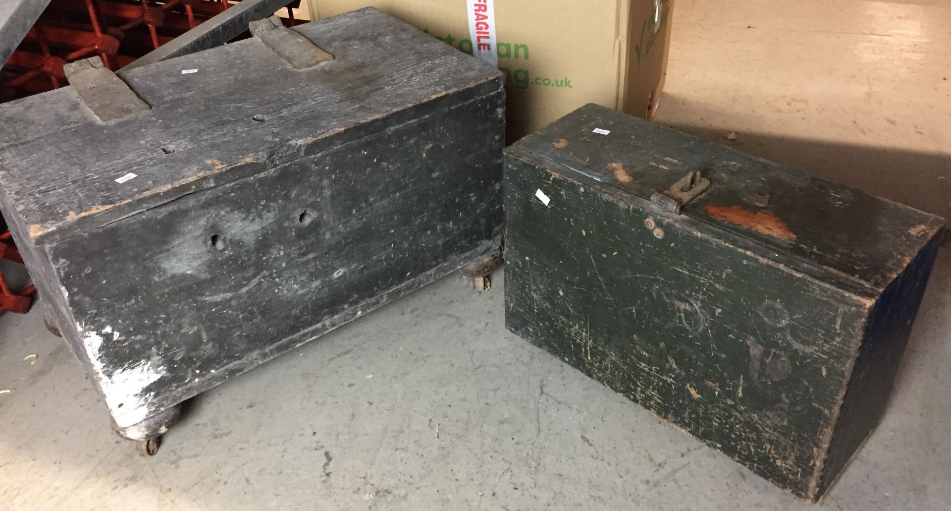 Two vintage wooden tool boxes - one 63cm x 39cm x 40cm high on bun feet with castors,