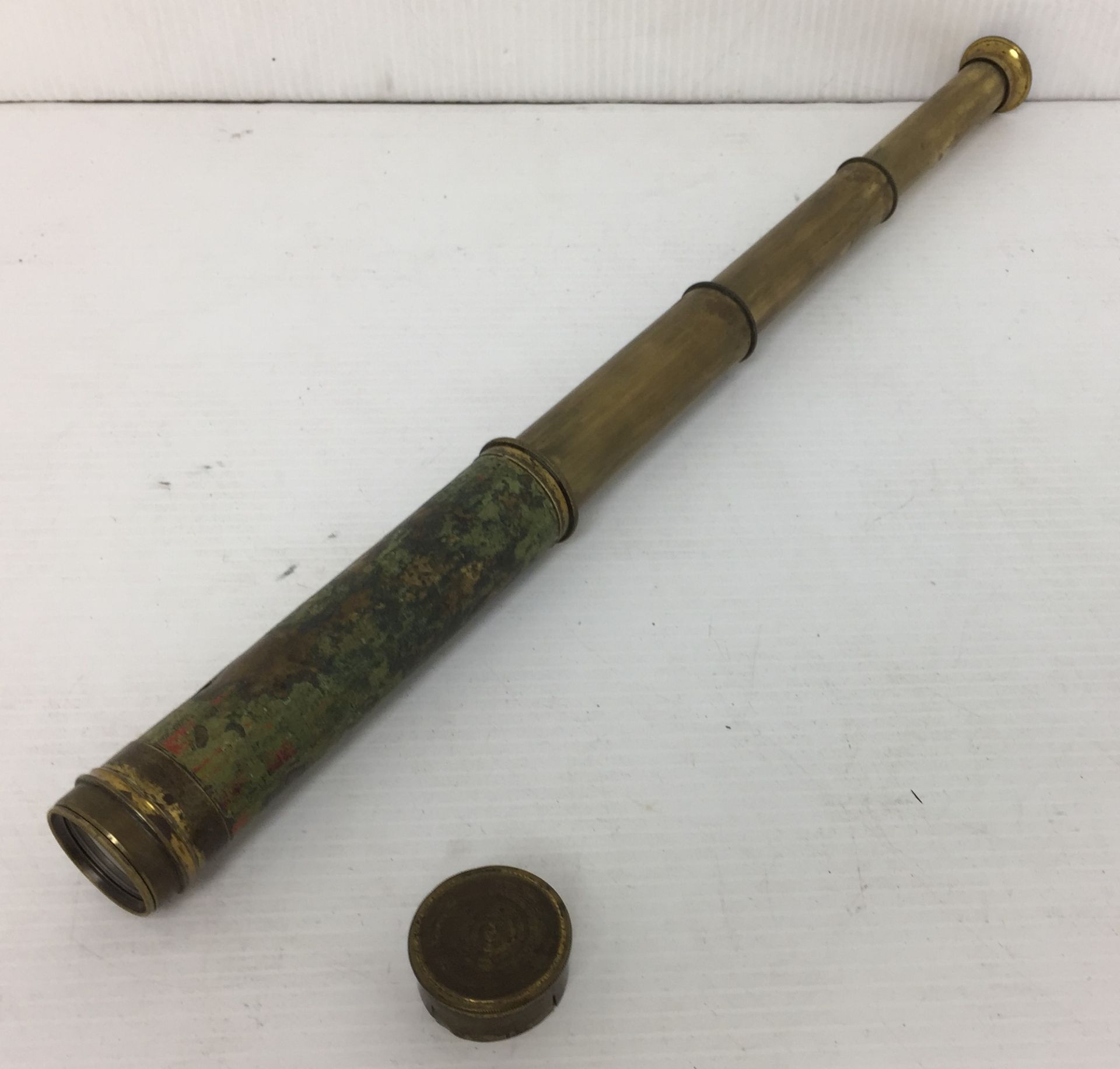 A brass telescope 42cm extended complete with lens cover,