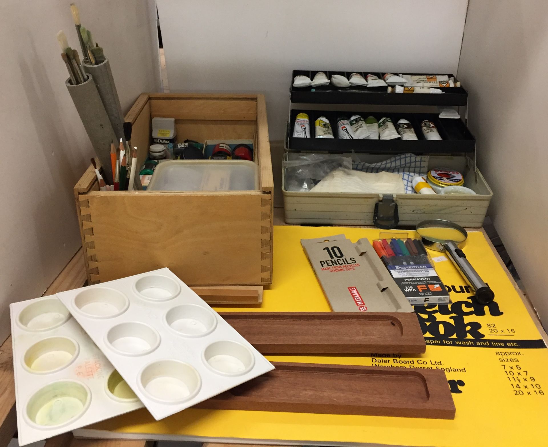 Contents to part of shelf - two artists boxes containing artists materials including paints,