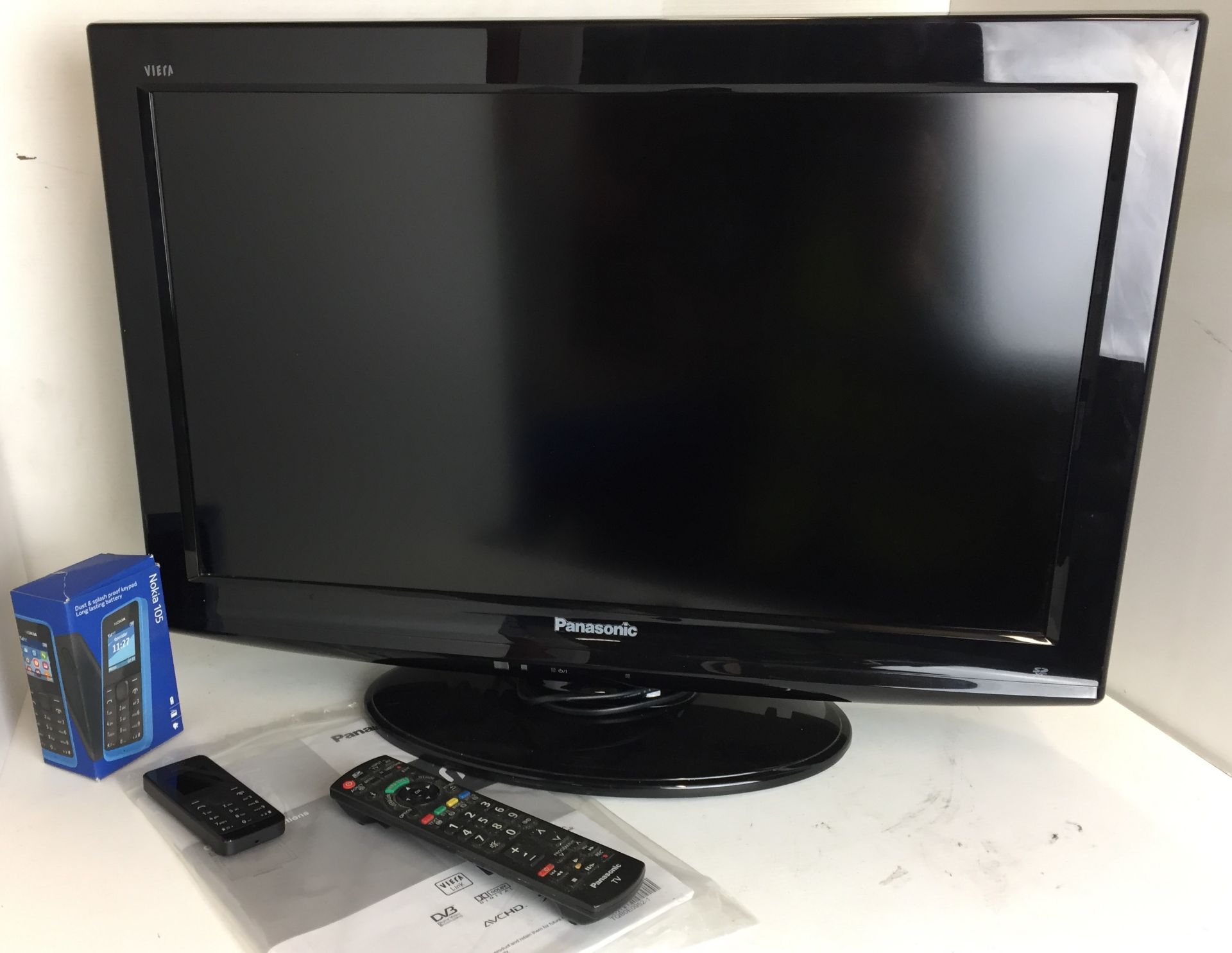 Two items Panasonic TX-L26C20B LCD television with remote control and instructions and Nokia 105