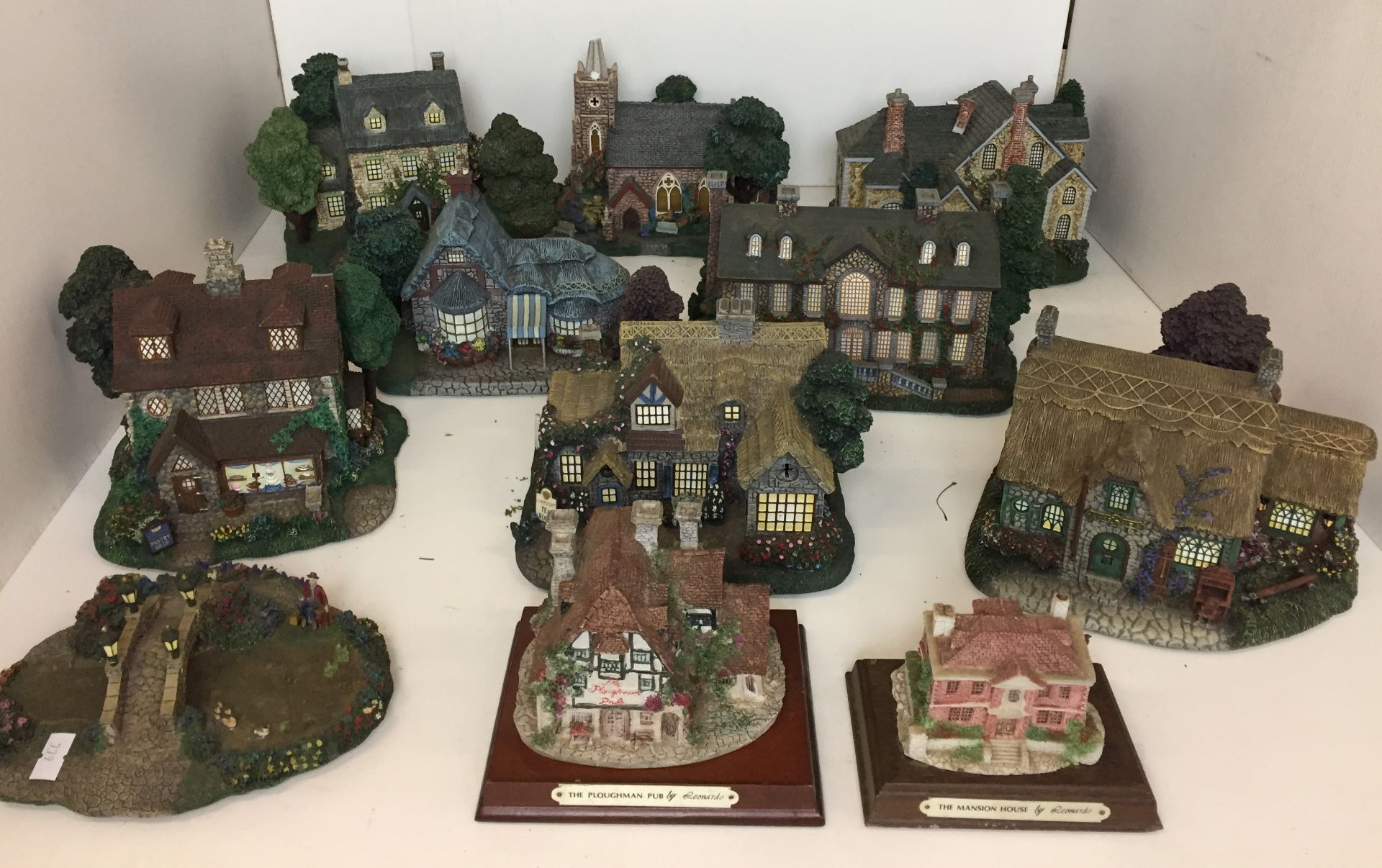 Eleven miniature buildings including two by Leonardo and nine - Hawthorne Village by Thomas Kinkade