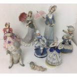 Eight items including two Lladro umbrella ladies 32 and 28cm high (both with damaged and/or