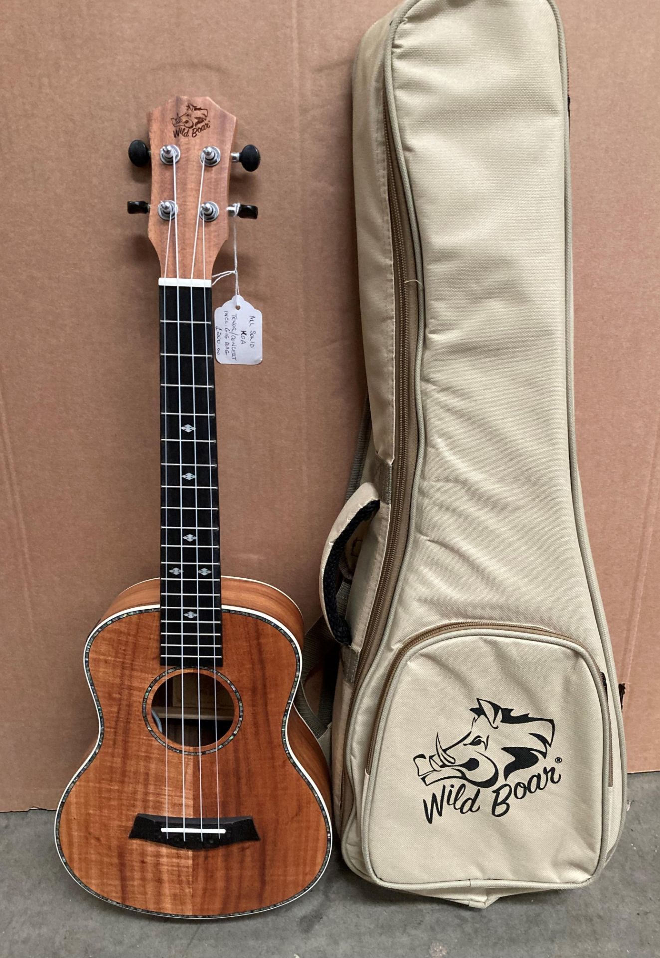 A Wild Boar Tenner Chinese four string ukulele complete with light brown bag (S1)