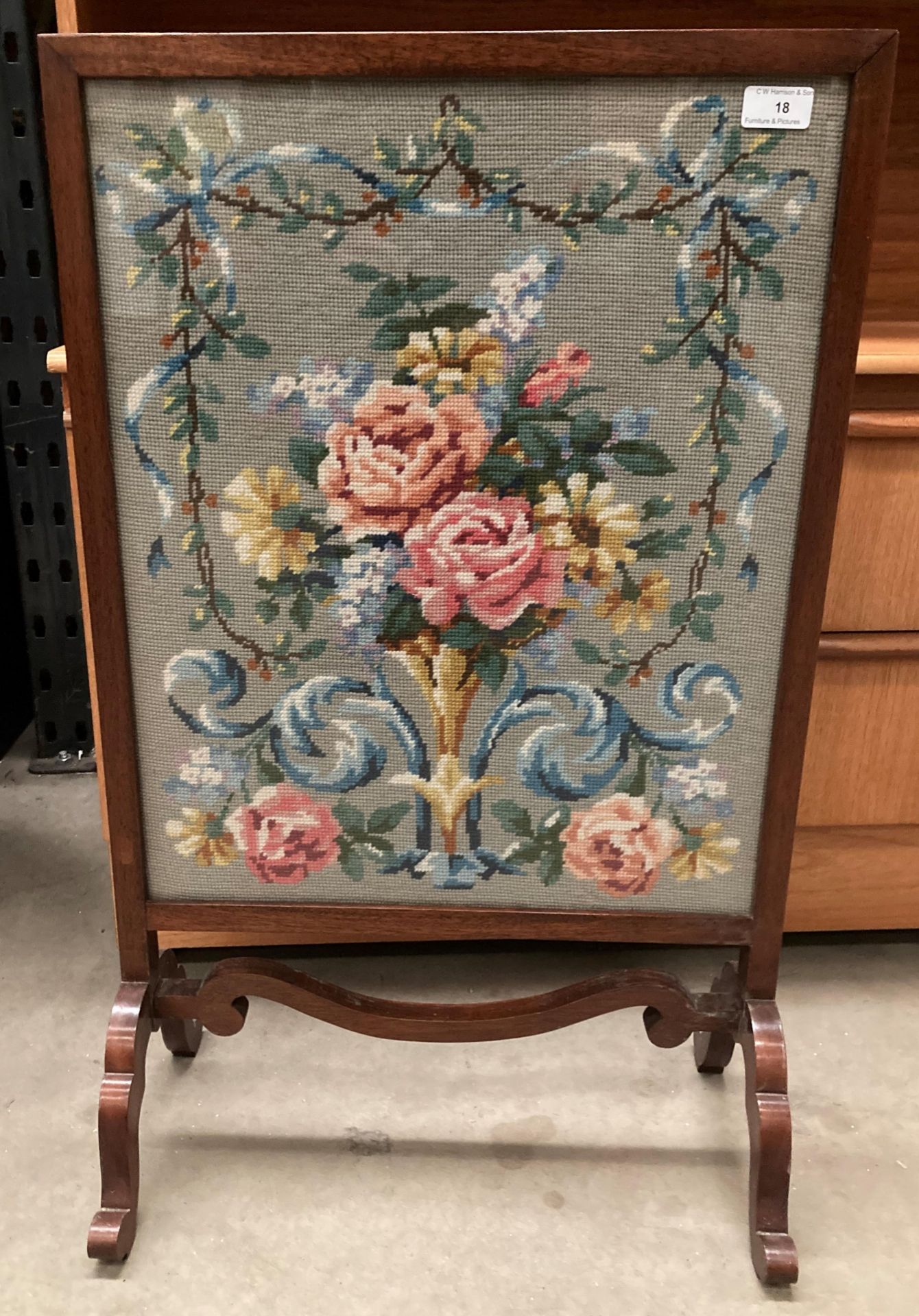 An oak framed fire screen with embroidered panel 54cm x 43cm