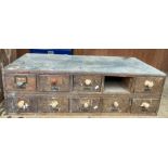 An oak table top ten drawer index cabinet (one drawer missing) 90cm x 43cm x 27cm