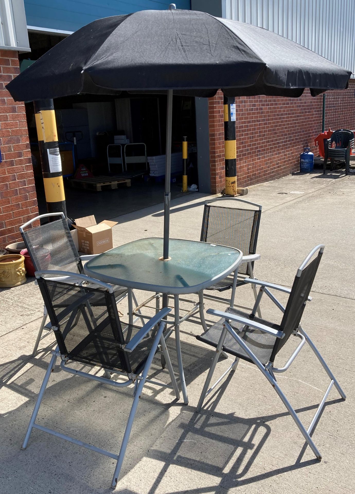 A grey metal patio set comprising table with glass top 80cm x 80cm,
