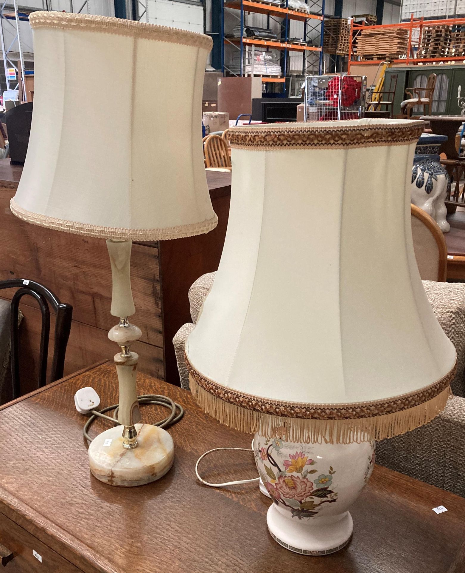 A white pottery floral patterned table lamp with shade and a green/brown onyx table lamp with shade.