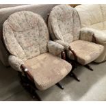 A pair of Dutialier wood framed rocking chairs with non matching cushions.