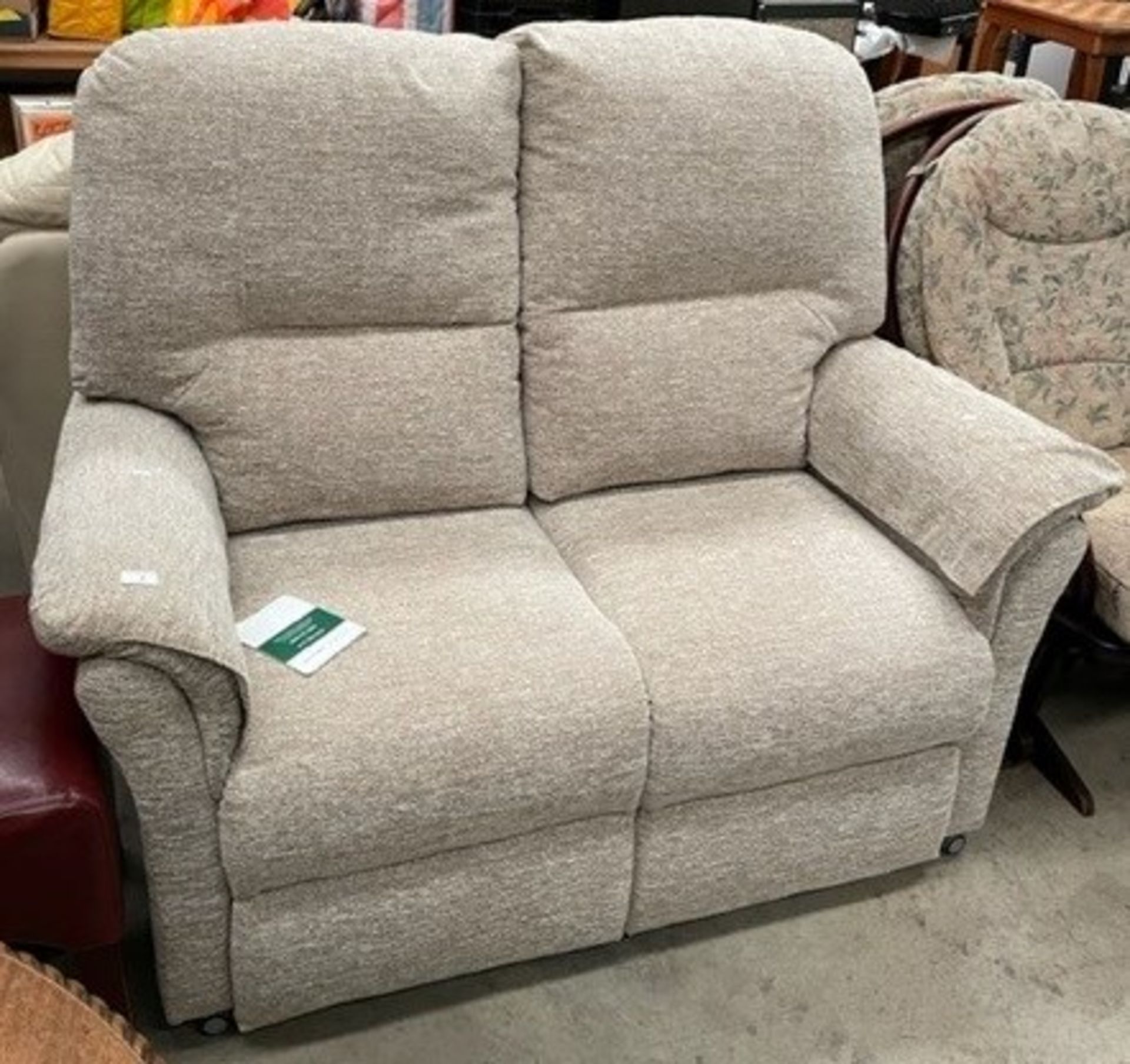 An Oaktree mobility oatmeal upholstered two seater settee