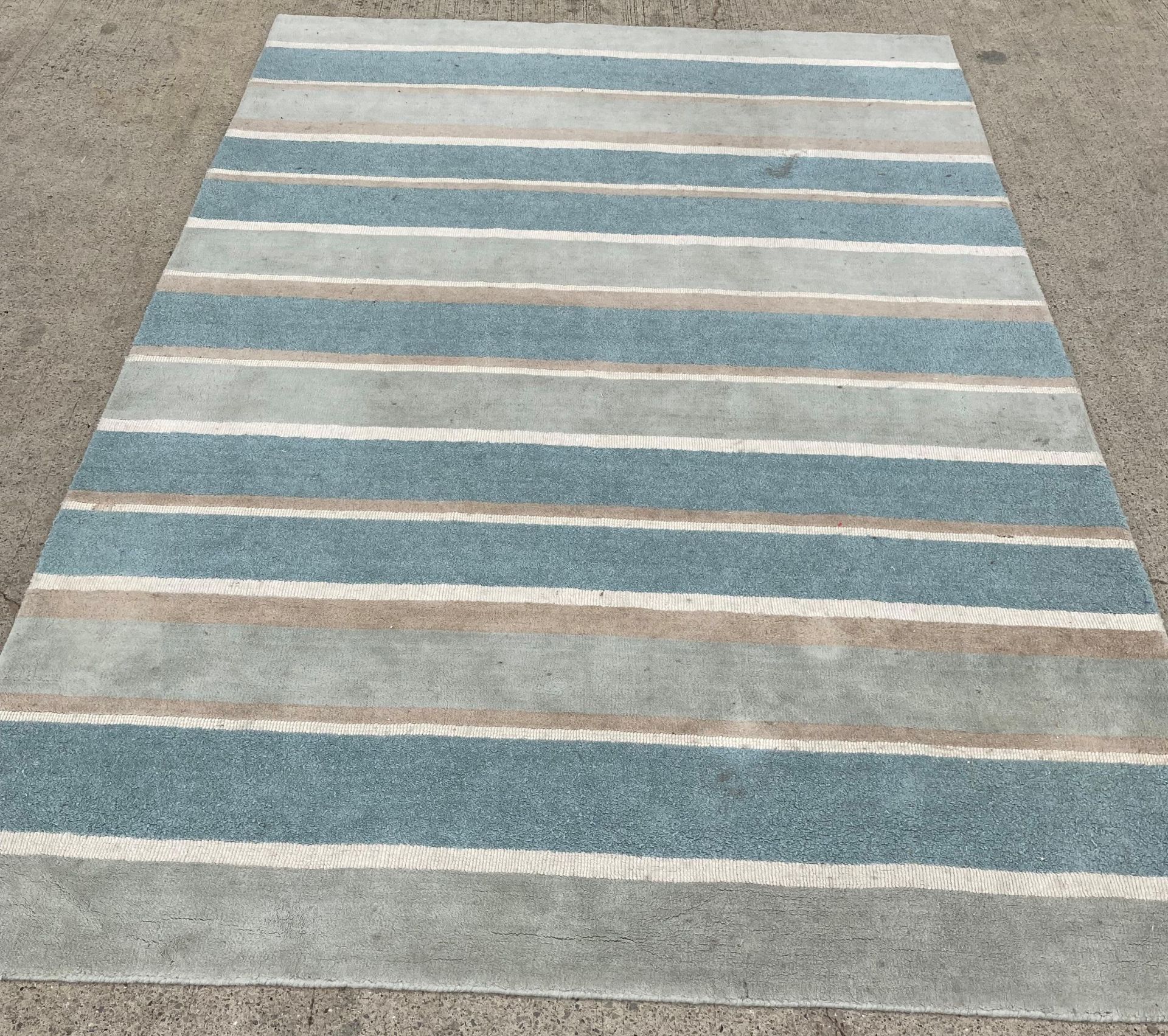 A Laura Ashley 100% wool, ref: K04 HF 801/74 light blue and beige striped rug,