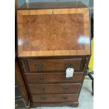 A reproduction walnut bureau, the fall front over four drawers on a shaped plinth base.