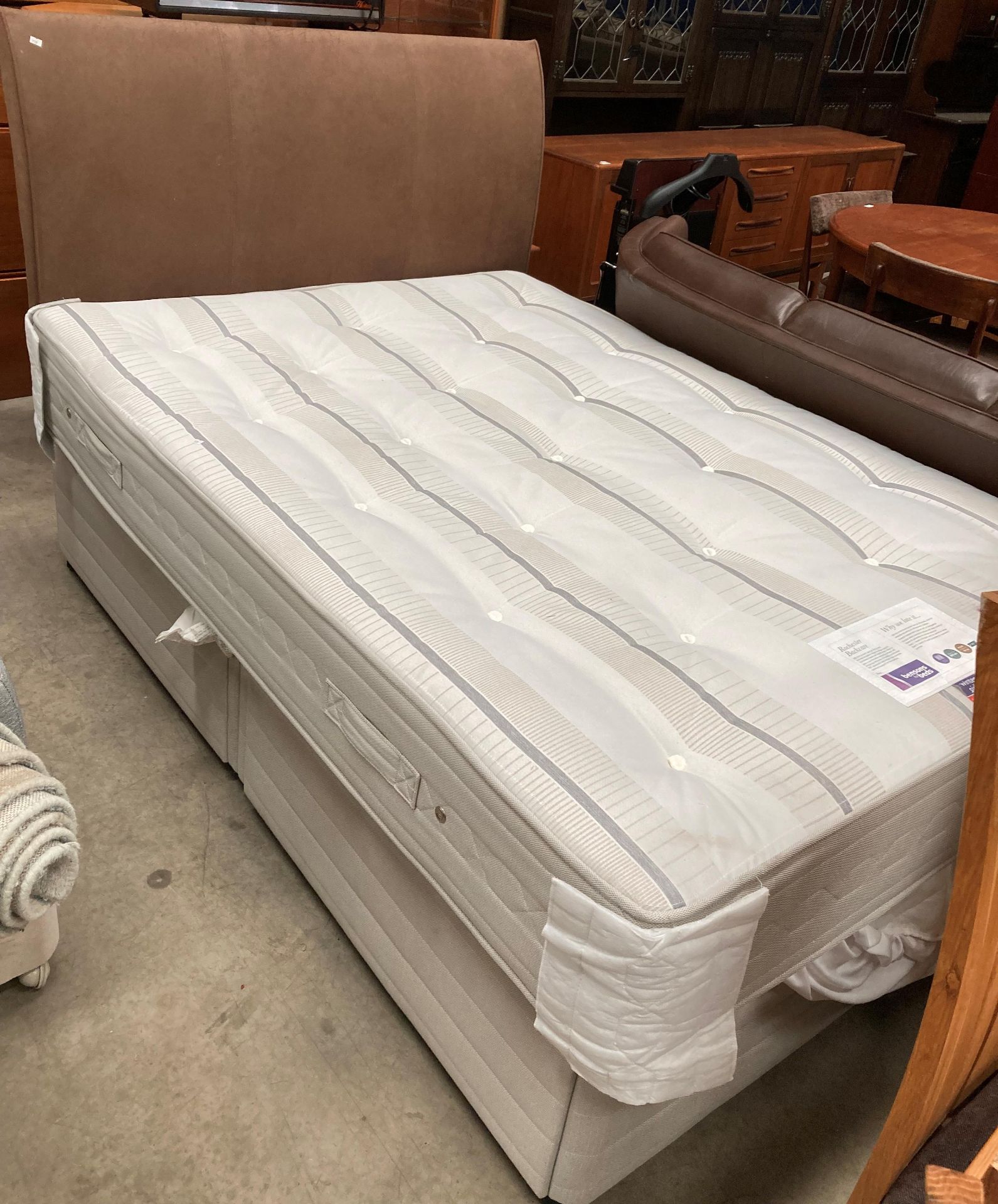 A 4' 6" four drawer divan bed base with Bensons For Beds dual winter/summer side mattress in grey
