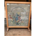 A light mahogany framed fire screen with needlework panel 50cm x 50cm - one foot damaged.