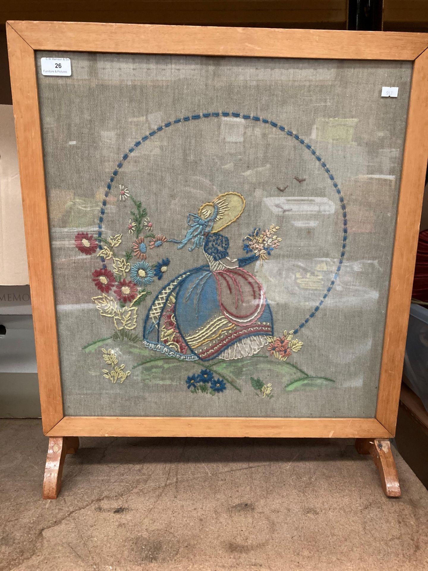 A light mahogany framed fire screen with needlework panel 50cm x 50cm - one foot damaged.