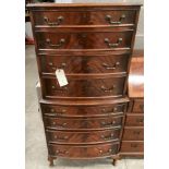 A reproduction walnut bow fronted chest on chest four drawers over four drawers 70cm x 140cm high