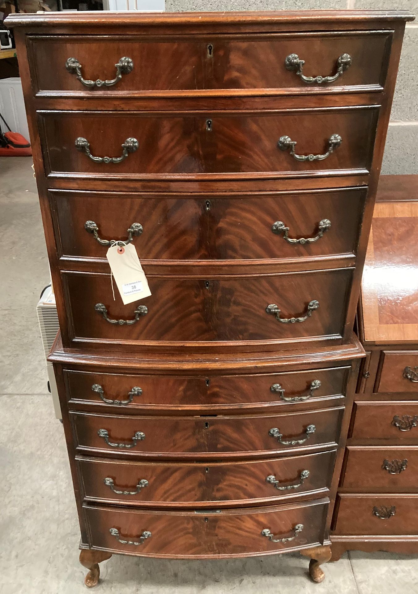 A reproduction walnut bow fronted chest on chest four drawers over four drawers 70cm x 140cm high