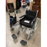 Black and grey framed wheelchair by Mobility and a three wheeled mobility walking aid
