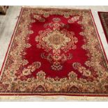 An Arakstan? 100% wool pile deluxe red ground carpet square with floral design,