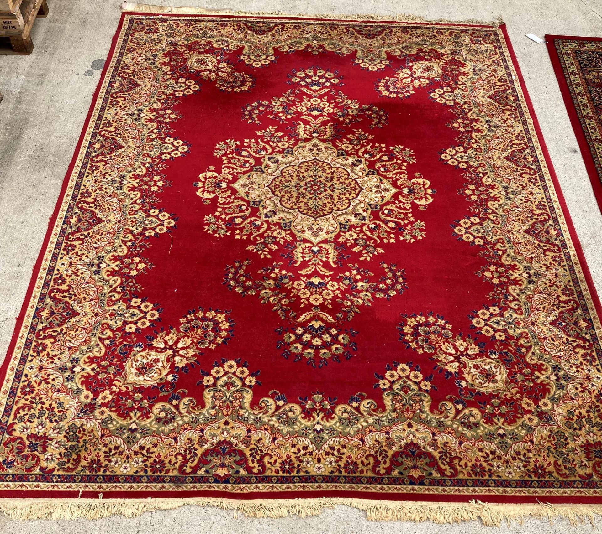 An Arakstan? 100% wool pile deluxe red ground carpet square with floral design,