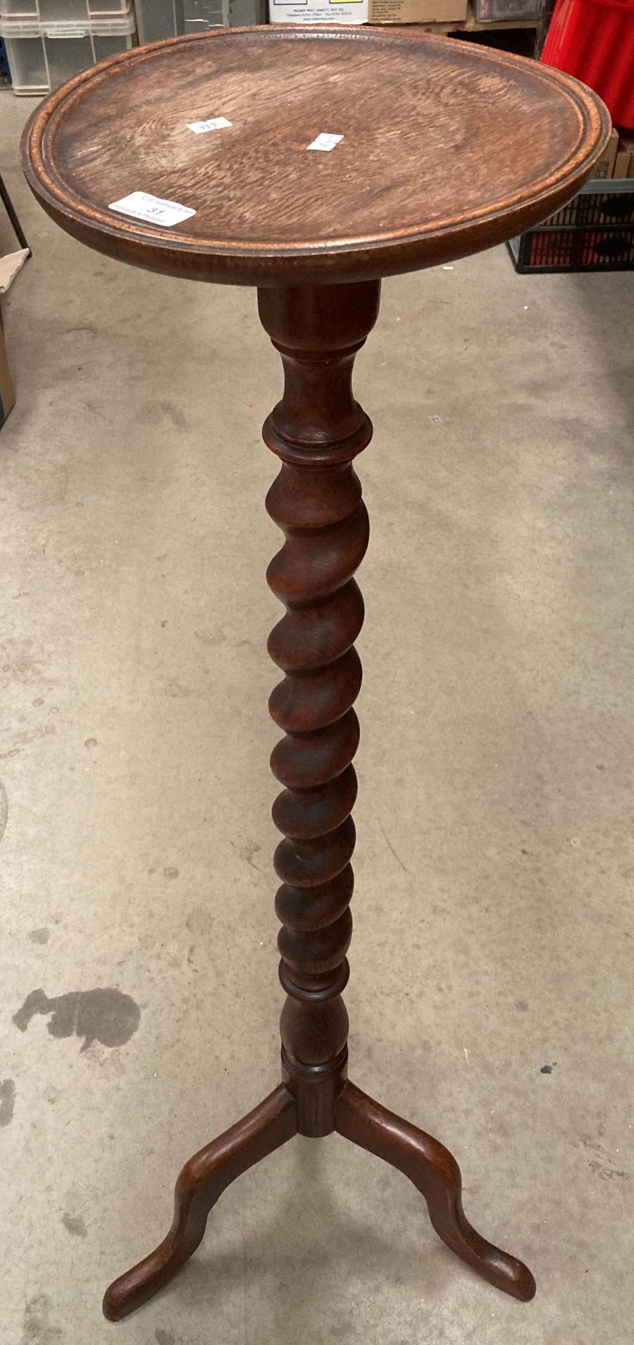 An oak plant stand with barley twist column on tripod base 125cm high, 30cm diameter - top warped.