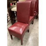 A set of six darker red leather effect high back dining chairs