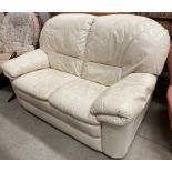 A beige leather two seater settee made by MTL.