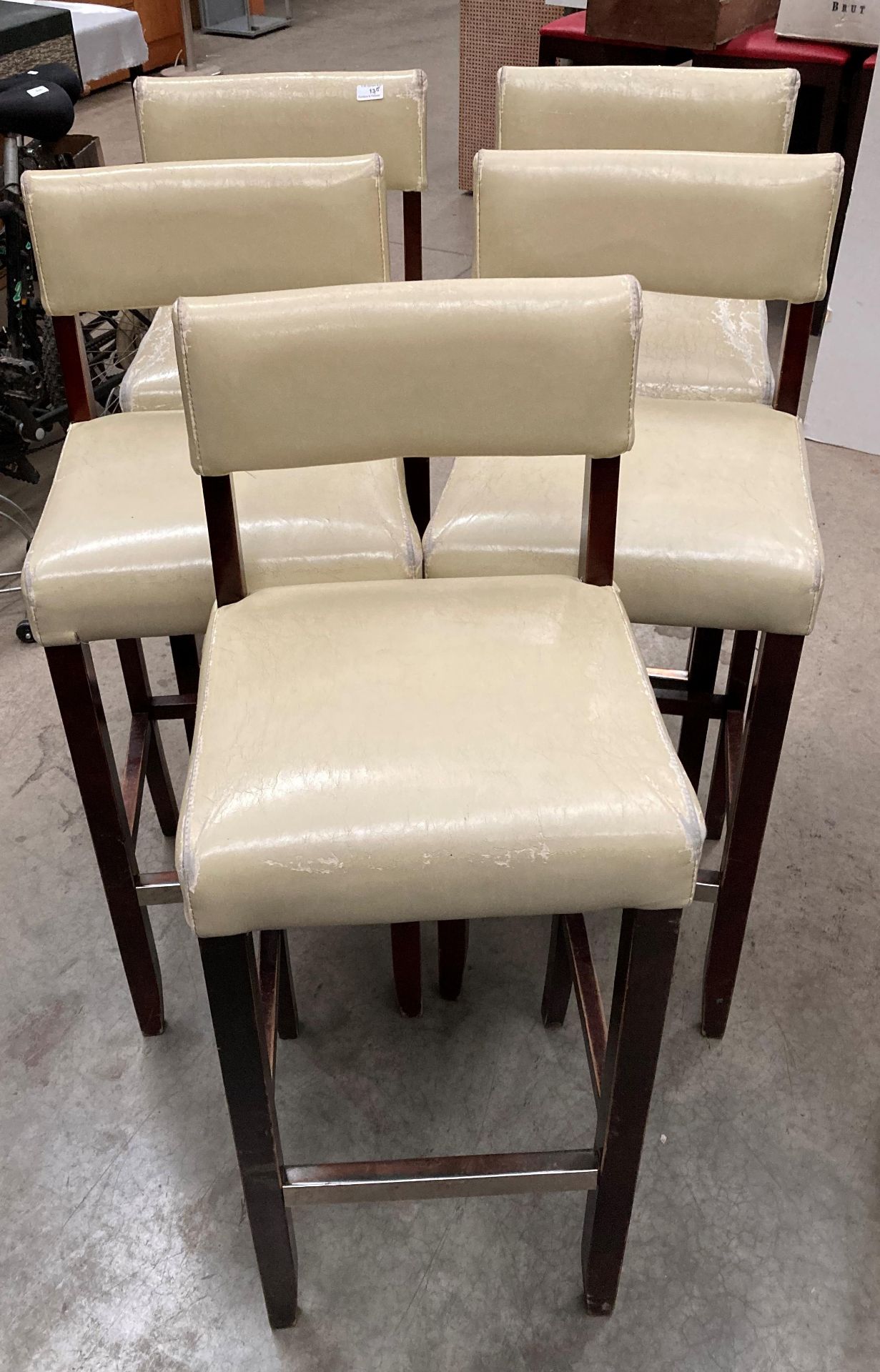 A set of five beige leather effect high bar stools - the upholstery is worn in places on all stools