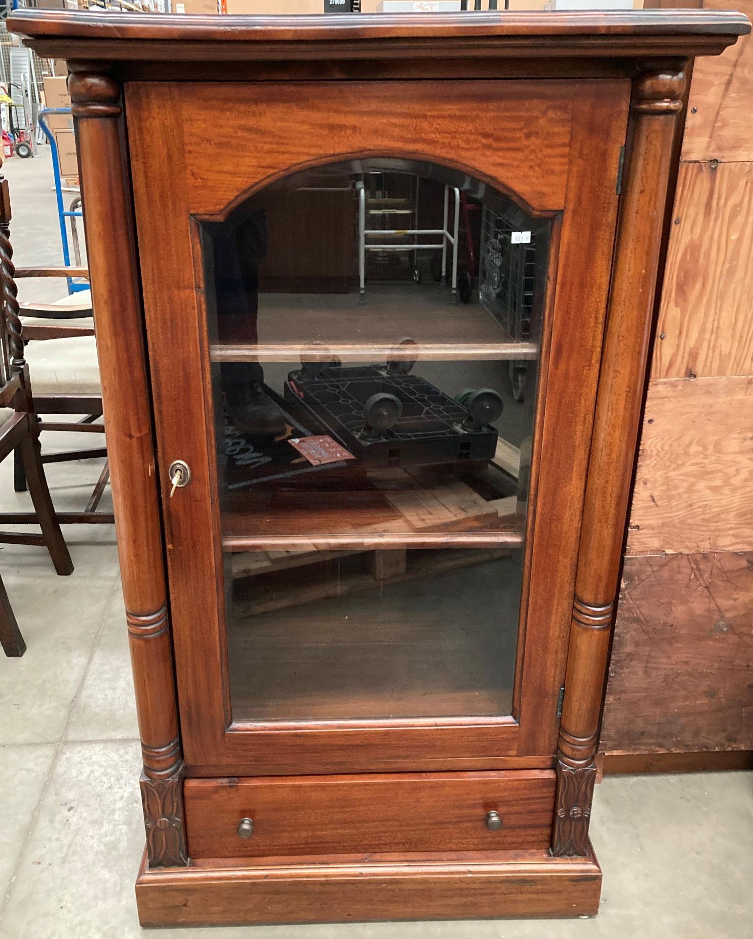 A mahogany single glazed door cabinet with three shelves and an underdrawer 72cm x 50cm x 127cm
