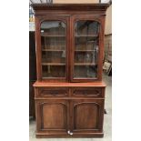 A Victorian mahogany bookcase/wall cabinet with two glazed doors over two drawer two door base