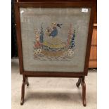 A mahogany framed folding fire screen/table with needlework panel 49cm x 49cm