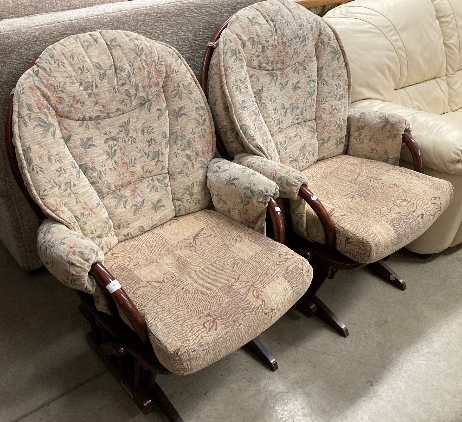 A pair of Dutialier wood framed rocking chairs with non matching cushions.