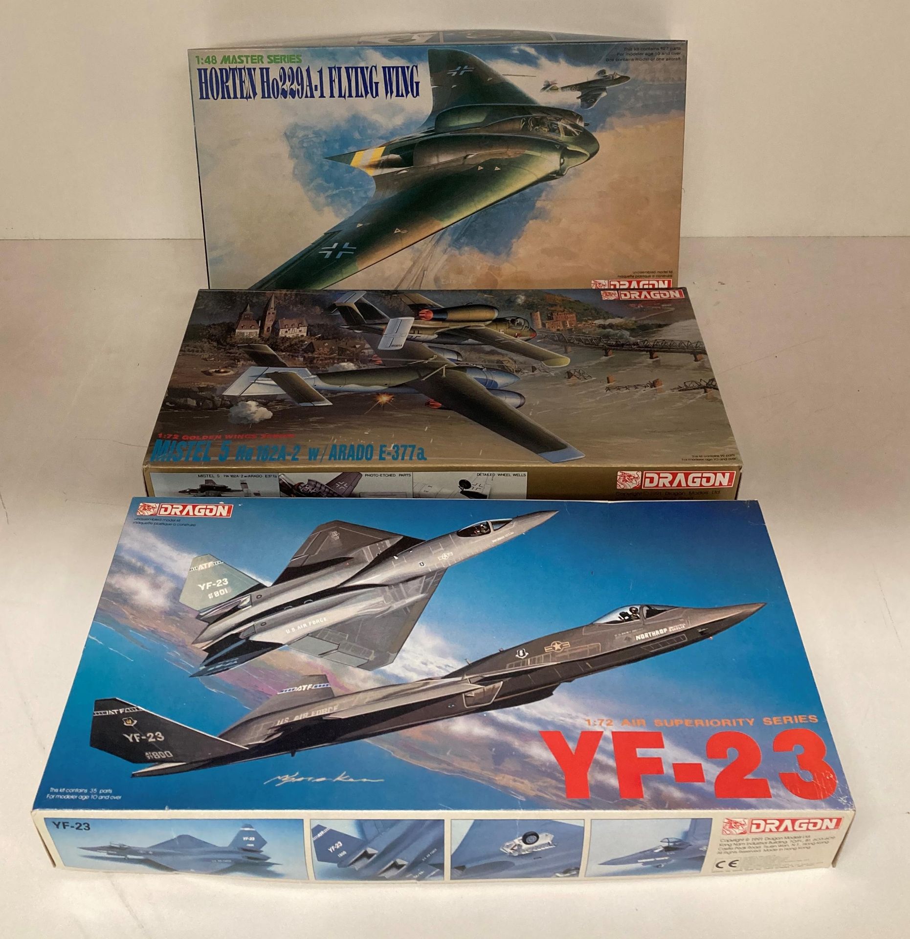 Three assorted model aircraft by Dragon including YF-23 1:72 scale,